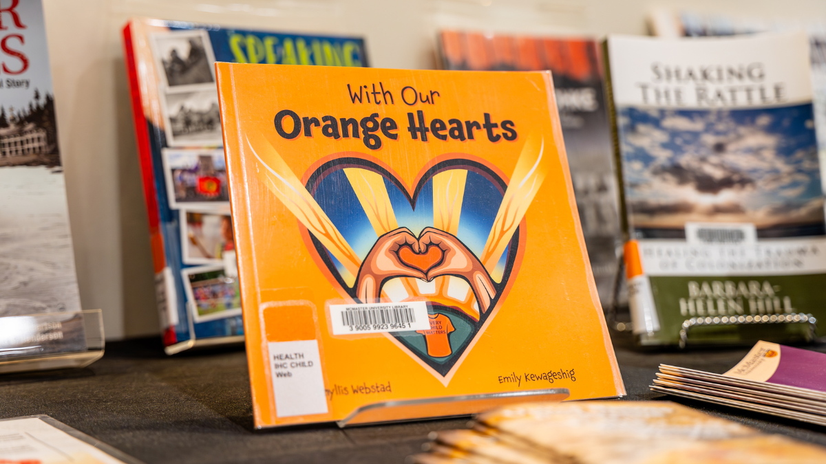 A close-up of the book: With Our Orange Hearts by Phyllis Webstad, which is sitting on the Health Sciences Library's curated collection of books for National Day for Truth and Reconciliation.